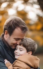 Fototapeta premium Minimalistic stock photo of a middle-aged man with light brown hair hugging his young son in a park, the boy has short brown hair