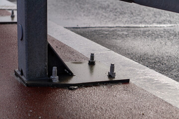 large screws connecting road energy barriers to the ground