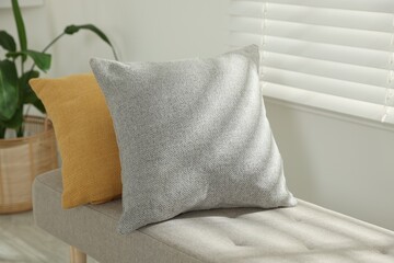 Soft decorative pillows on sofa in room