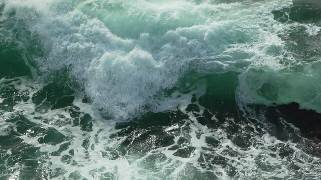 Ocean Waves Crashing: Powerful wave breaks on a sunny coast, demonstrating water's natural strength