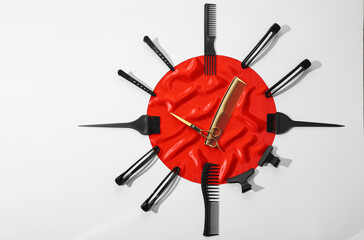 Clock made with hairdresser's tools on white background, flat lay