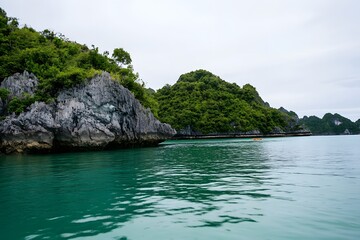 Naklejka premium Tropical islands rise from turquoise water beneath a cloudy sky
