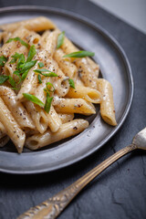 Penne with ground pepper and Gorgonzola creamy sauce, sprinkle with chopped chives.