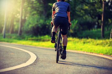Cyclist riding bike at summer park