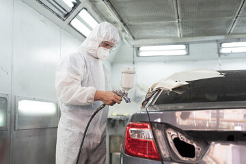 Painting car parts concept. Metal part of frame car. Automotive paint services. Auto mechanic...