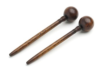 Dark wooden percussion mallets on white background for musical performance and artistry