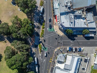 Aerial view of Auckland, New Zealand, showing cars and buses moving along a city street....