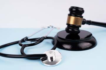 Gavel and stethoscope close up. Law and medical health concept.