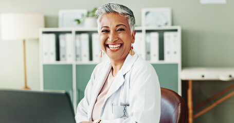 Mature, doctor or happy woman with portrait, healthcare or confidence for wellness in clinic. Laptop, office and person in hospital for career, pharmaceutical medicine or medical service in Mexico