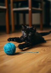 Playful Kitten Pouncing on Yarn Ball