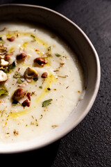 Cauliflower soup with hazelnuts and aromatic herbs. Wnter comfort food and plant based.