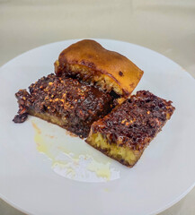The most popular Indonesian specialty full of chocolate, peanuts and butter is called Martabak Bangka on white plate.