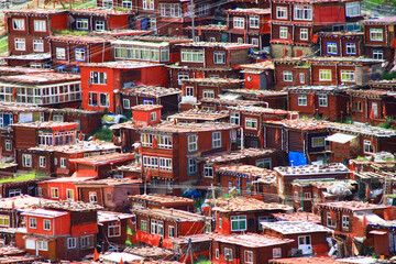 Vibrant red houses in a lovely tibetan village.