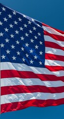 Fototapeta premium Waving Glory: Capturing the Essence of the American Flag under Bright Sky