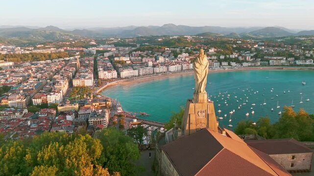 Sunset view over the statue of Christ in San Sebastian town, Basque, Spain 