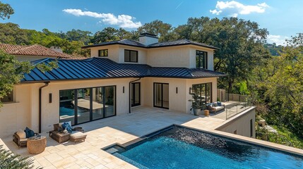 Fototapeta premium Modern home with pool and patio. Spacious outdoor living area featuring a large swimming pool, deck, and patio furniture.