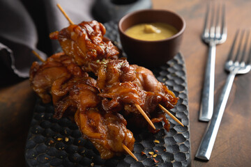 Smoked chicken pieces on a skewer