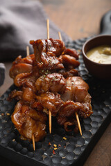 Smoked chicken pieces on a skewer