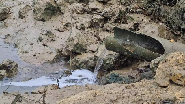 Water flows from the pond to the river through the paralon pipe