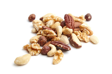 A scattered assortment of walnuts, pecans, cashews, almonds, hazelnuts, and Brazil nuts, highlighting their textures and natural colors on a white background
