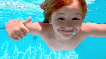 Child swimming in pool. Swimming underwater fun. Kid enjoying poolside. Active kid swimmer in water. Summer pool activities. Playful boy swimming in pool. Kid splashing in water. Fun kids swimming.