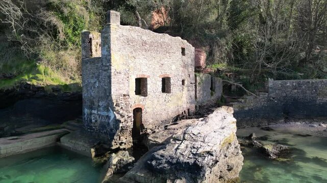 Torbay, Devon, England: DRONE VIEWS: The drone circles an abandoned Victorian bathing house at Elberry Cove. South Devon is a popular UK holiday destination renowned for its beautiful coastline (1).