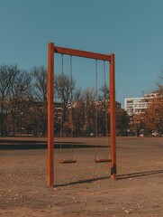 Obraz premium Empty wooden swing set in a park on a sunny day. A nostalgic scene of childhood memories.