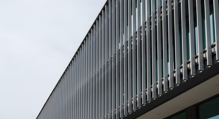 Modern architectural facade featuring vertical aluminum fins for sun control