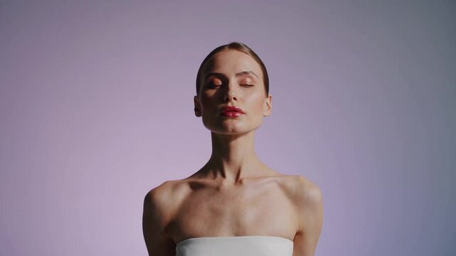 A surreal, cinematic mid-shot of a woman standing still against a soft gradient background, wearing a white strapless top.