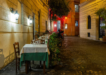 Night cozy old street in Trastevere in Rome, Italy. Trastevere is rione of Rome, on west bank of Tiber in Rome. Architecture and landmark of Rome