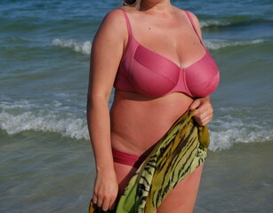 woman at sea with big breasts size 6 posing on the beach woman in bikini on beach