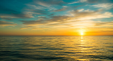 Obraz premium Serene Ocean Sunset with Golden Reflections and Tranquil Teal Sky Panorama