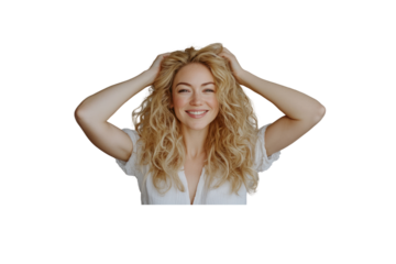 A light-hearted portrait of a blonde woman with curly hair, her face lit up by a warm smile, set against a smooth gray backdrop. Her expression conveys a sense of ease and happiness.