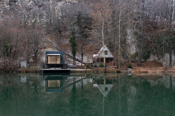 Houses reflected in the mountain river Morava in Serbia