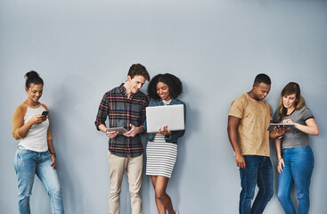 Group, business people and waiting with technology in studio, app or vacancy test with laptop. Gray...