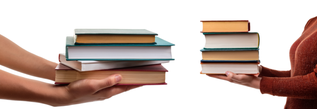 Two hands exchanging a stack of books in a warm, friendly setting.