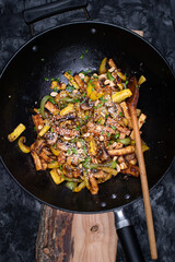 Vegan tofu, mushroom, pepper and squash stir fry in wok