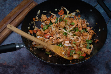 Vegan tofu, cabbage and peper stirfry in wok