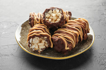 Delicious chocolate puffed rice bars on gray textured table, closeup