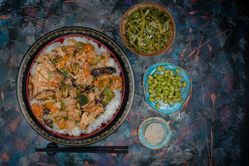Vegan chirashizushi  made with yuba, shiitake, broccoli and pepper in traditional bowl along with wakame, edamame.