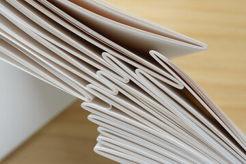 top down view of stacks of nested, folded papers on a defocused wooden background