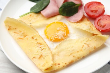 Delicious crepe with egg, ham and parmesan cheese on table, closeup