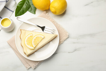 Piece of delicious lemon cheesecake served on white marble table, flat lay. Space for text