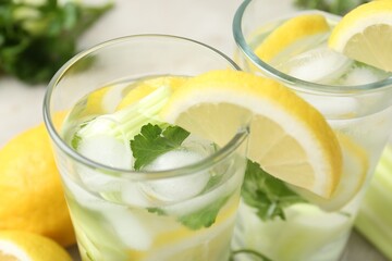 Fototapeta premium Healthy drink with parsley, lemons and celery on table, closeup