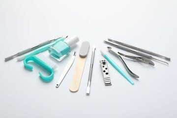 Set of different manicure tools on white background, closeup