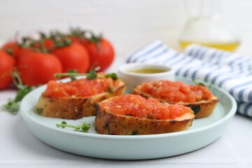 Tasty bread with tomatoes, microgreens and oil on white table, closeup