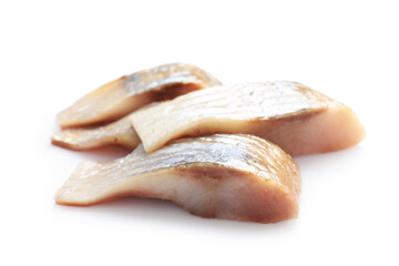 Pieces of delicious herring isolated on white