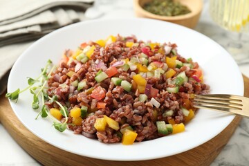 Tasty salad with brown rice on white table, closeup