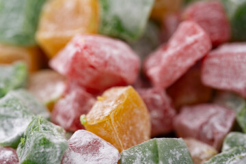 Colorful assorted fruit candies arranged with sugar coating in a close-up view on display