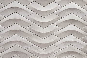 Wavy concrete brick wall texture. Modern architectural surface with flowing pattern. Grey...